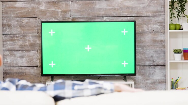 Man Relaxing on Sofa Watching Television with Green Screen