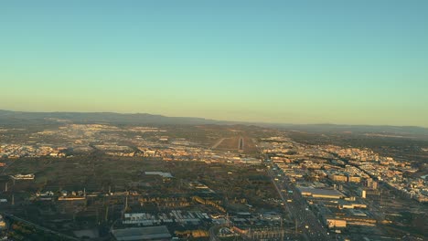 aerial view of airport and cityscape at sunset