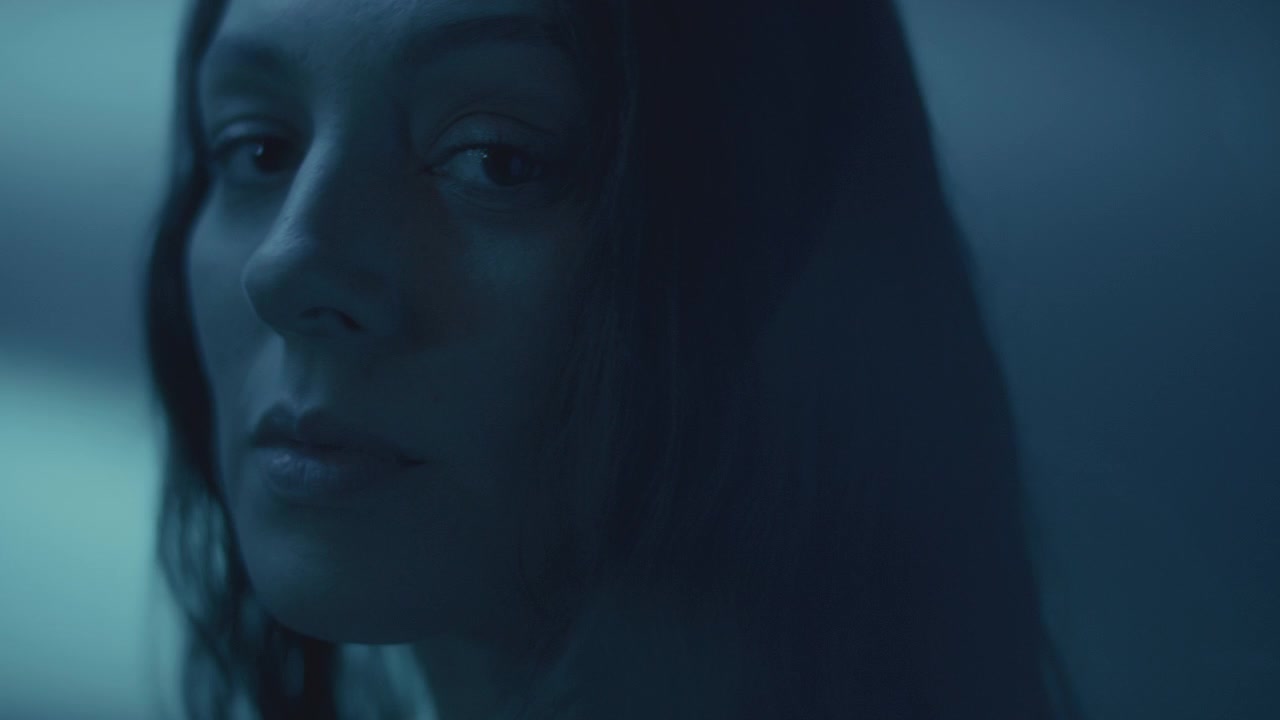 Close Up Portrait of Contemplative Woman under Cold Blue Light
