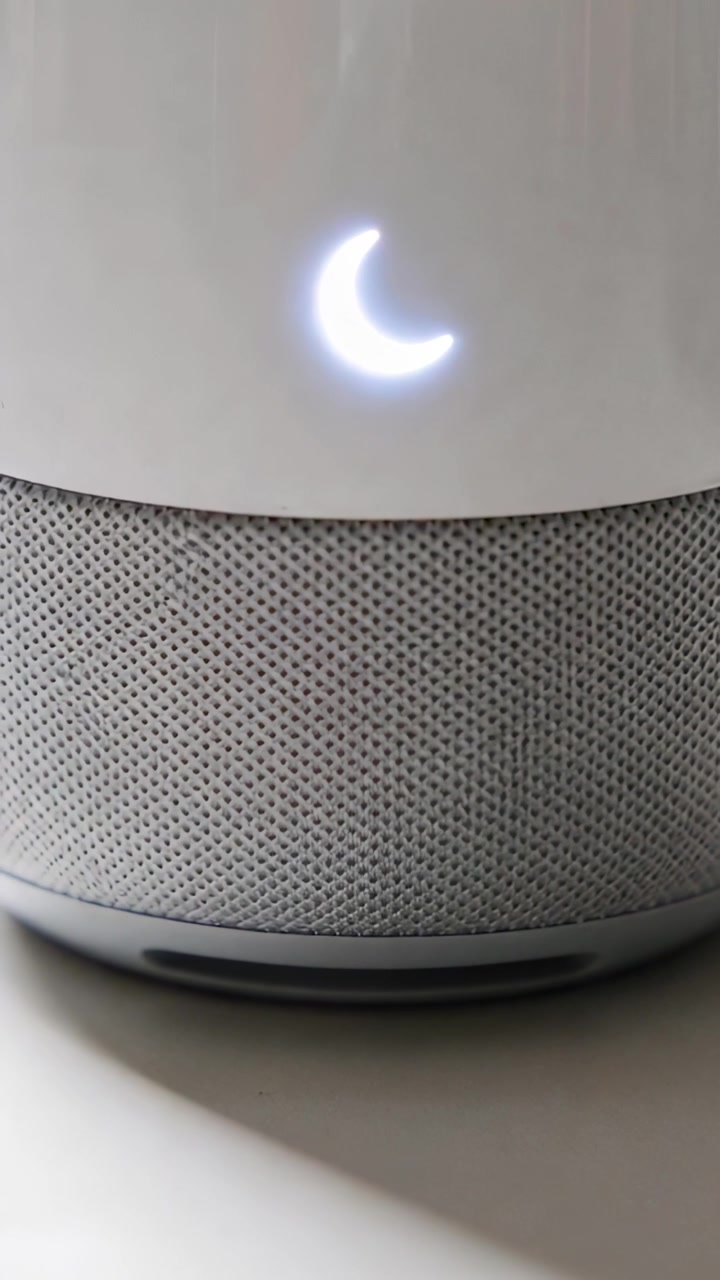 Vertical video: Showing crescent LED woven speaker sitting on table in home indicating standby