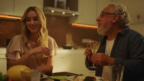 man talking with daughter in law on kitchen. mature man gesturing with hand