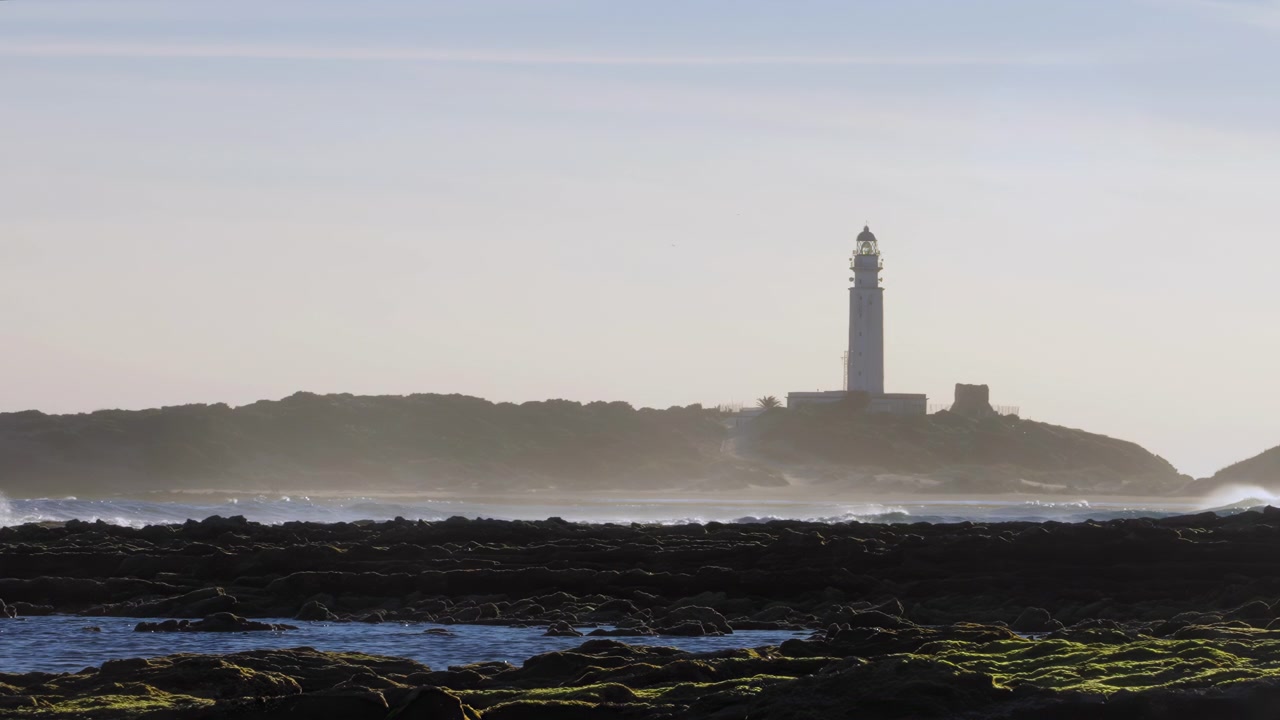 Costa di Trafalgar con faro sullo sfondo, Cadice, Spagna.