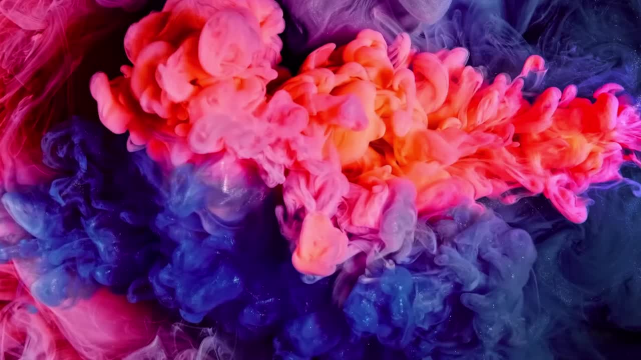 Premium stock video Abstract mix of pink and blue colored ink in water