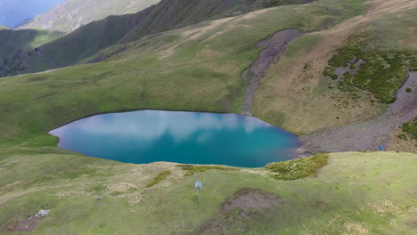 cinematic rotating drone shot of oreit lake in tusheti georgia, in the caucasus mountains