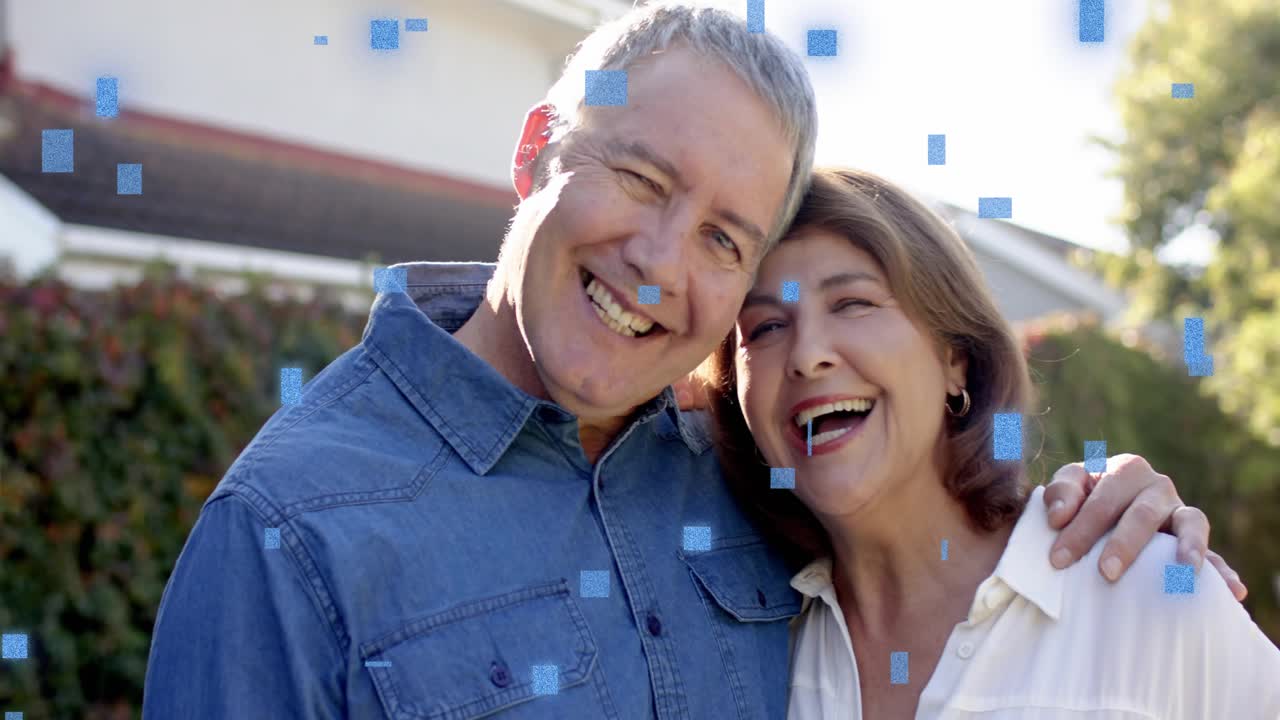 Couple standing outside home, man speaking initiating smiles as blue squares drifting for realty ad