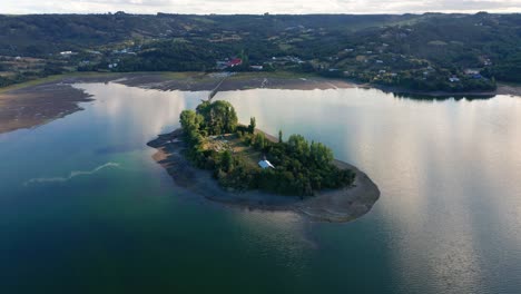 aerial view of aucar island connected to island of chiloe by wooden walkway