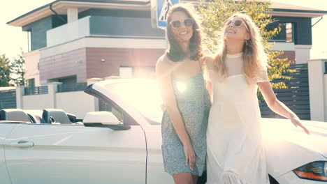 two friends enjoying a sunny day in a convertible car