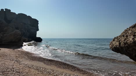 tranquil beach scene with rocks and calm sea