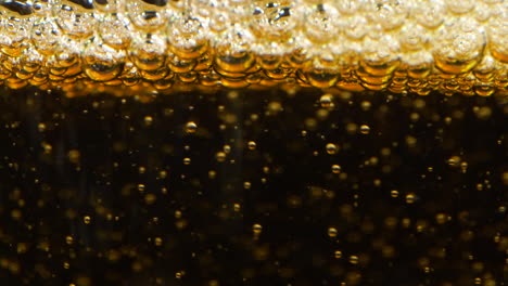 extreme close up of apple cider being poured into glass, normal speed