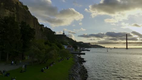 static drone shot of river side in almada, portugal