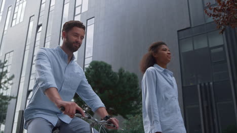 happy bearded man riding bicycle on downtown street. urban city traveler concept