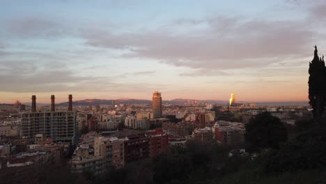 barcelona three chimneys panoramic skyline of the city from montjiuc hills town under golden sunset, aerial view