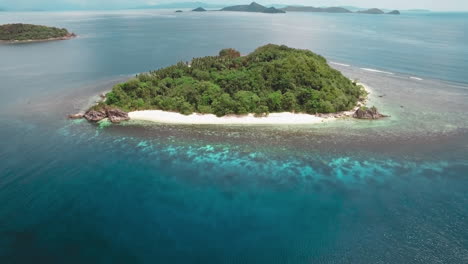 dolly in establishing shot of a small beautiful island with white sand in el nido palawan philippines