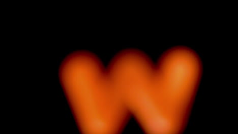 the letter w coming into focus on black background