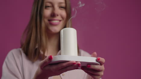 woman holding a lit candle
