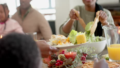 African-american-parents,-children-and-grandparents-celebrating-at-thanksgiving-dinner,-slow-motion