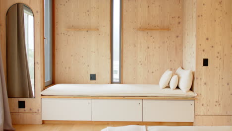 cozy wooden nook with cushions and natural light in modern home, copy space