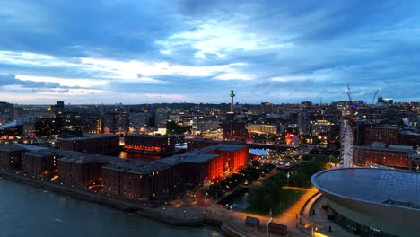 aerial view of liverpool cityscape illuminating at dusk, showcasing the historic royal albert dock and the iconic radio city tower