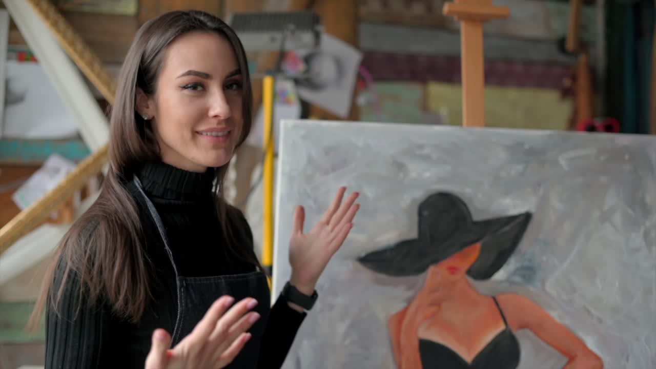 Woman presenting a painting at an art gallery workshop