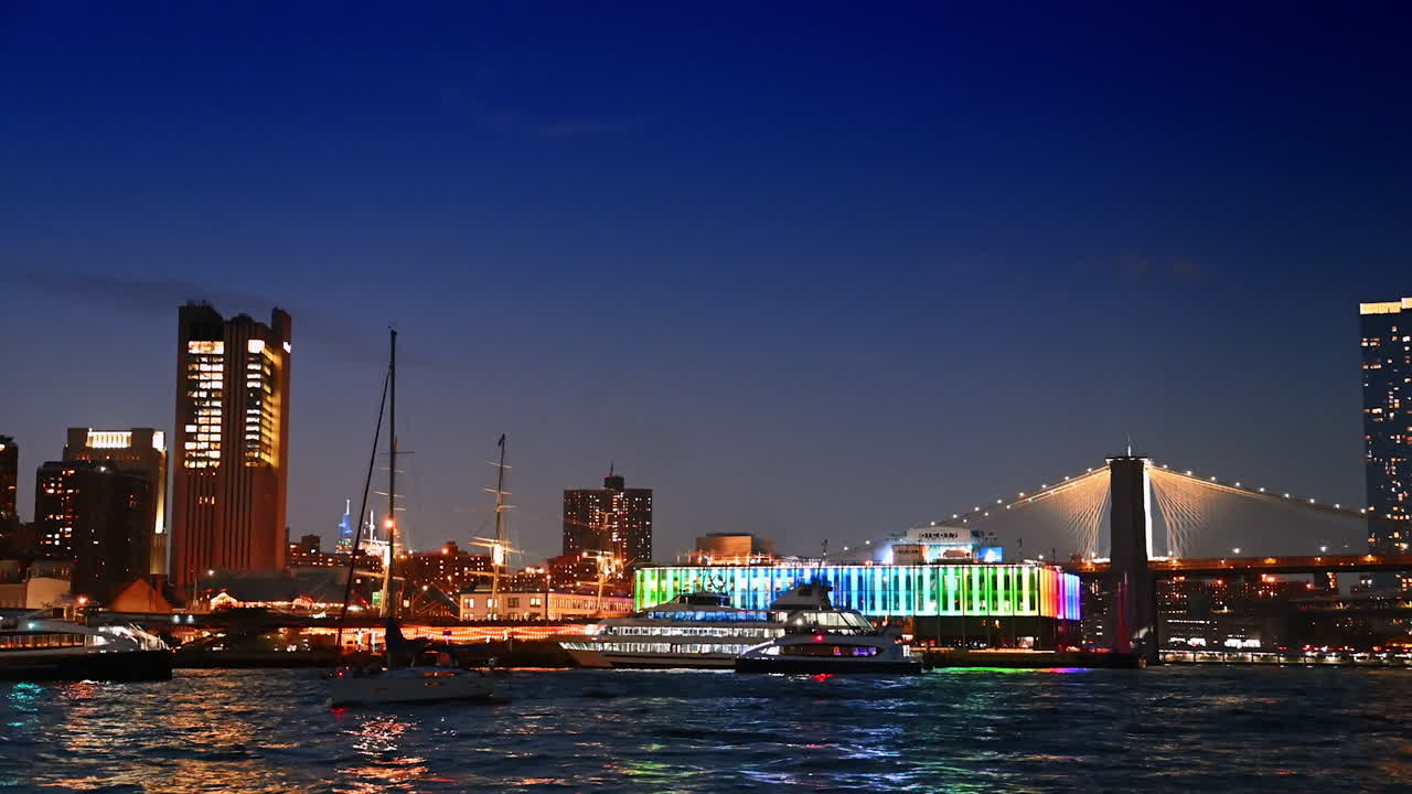 Boats and riverboats on the riverscape of the East River. Approaching Pier 17 Bar and the Brooklyn Bridge