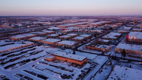 industrial area covered in snow during sunset