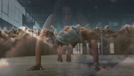animación de nubes sobre una deportista afroamericana haciendo flexiones