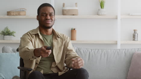 Man in Wheelchair Holding Remote