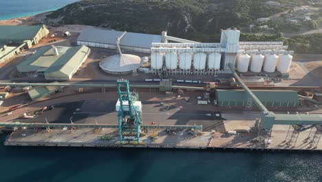 industrial port with crane beside grain factory in esperance town,western australia