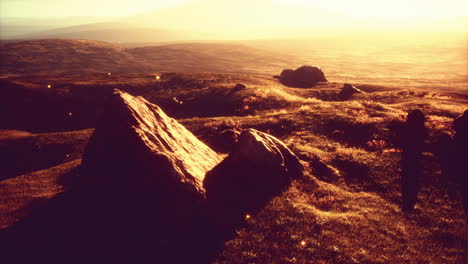 golden hour sunset over mountains and field