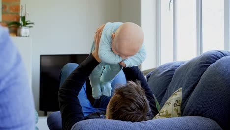 Father-playing-with-his-baby-boy-in-living-room-4k