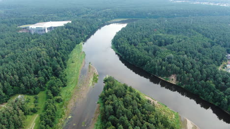 modern snow arena building exterior in druskininkai near river nemunas, high angle drone view