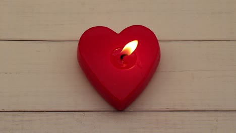 red heart shaped candlelight on wooden background.video 4k