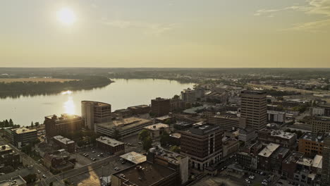 Evansville-Indiana-Aerial-v8-drone-flyover-town-center-capturing-sunset-downtown-cityscape,-showcases-a-mix-of-modern-and-historic-buildings-by-the-river---Shot-with-Mavic-3-Pro-Cine---September-2023