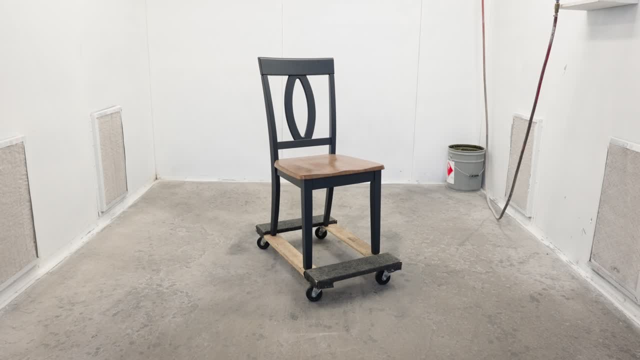 Camera tilts up from floor and moves in to reveal painted chair in enclosure