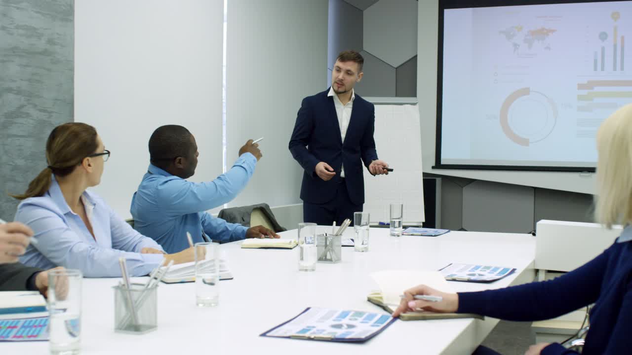Young Man Explaining Presentation to Business Team
