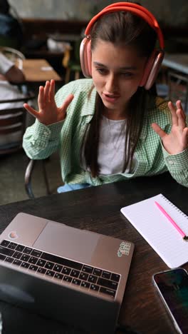 una mujer joven estudiando en un café.