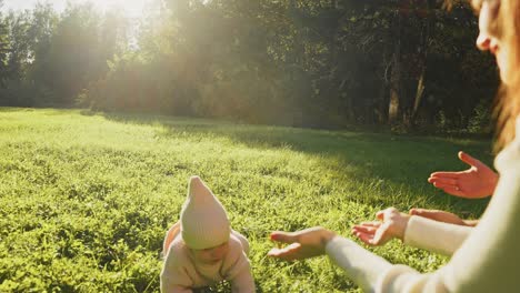 baby learning to walk in a park