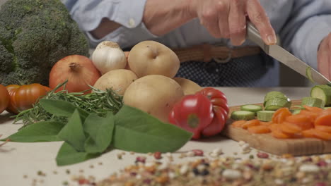 mujer cortando verduras calabacín, comida de dieta mediterránea, comida vegetariana vegana