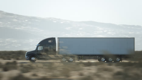 semi truck driving on a desert highway