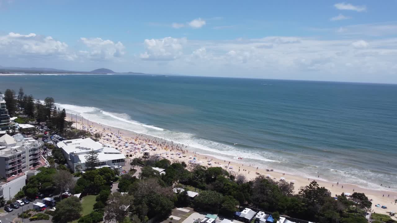 Sweeping 4K aerial view of a coastal town in Australia with beautiful sandy beach