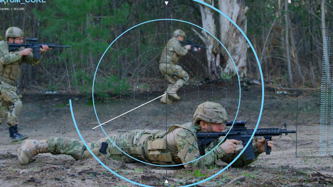 Prone soldier aiming rifle on soil while teammate entering left and initiating HUD sweep, training