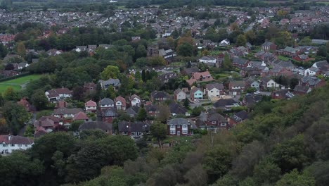 Aerial-view-above-Halton-North-England-coastal-countryside-town-estate-green-space-houses-orbit-left