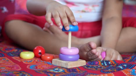 child playing with a baby toys on bed, child development concept.