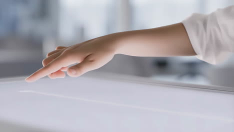 hand interacting with a digital touchscreen or interactive table