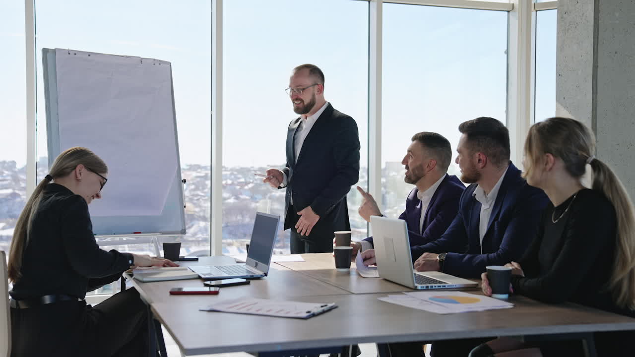 Speaker is having presentation of ideas with the help of a chart. Middle-aged confident employee promoting new ideas.