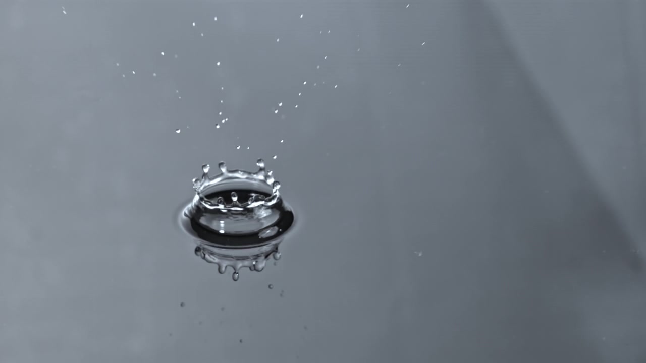 Slow Motion Water Droplet Falling and Creating Ripples