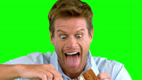 attractive man about to eat a cake on green screen