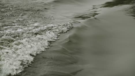 wake from fishing boat on alaskan river