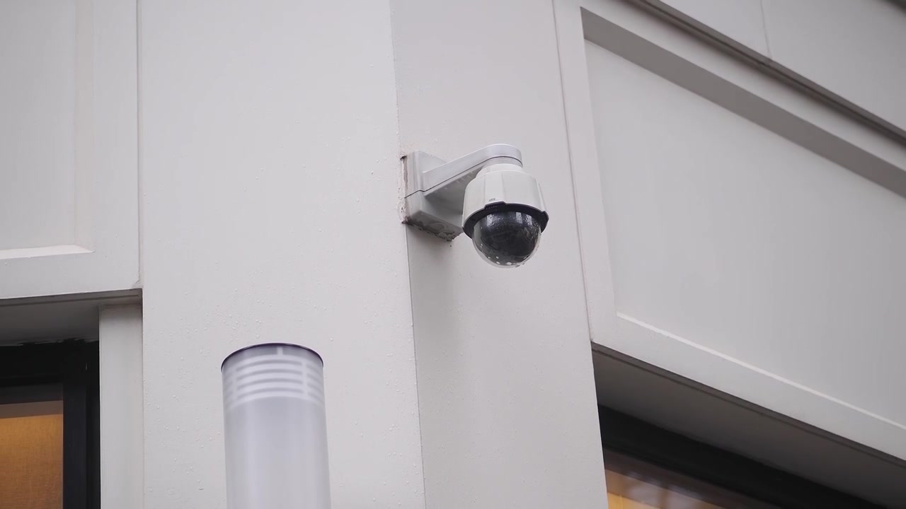 Outdoor Security Camera Monitoring a Building in the Rain