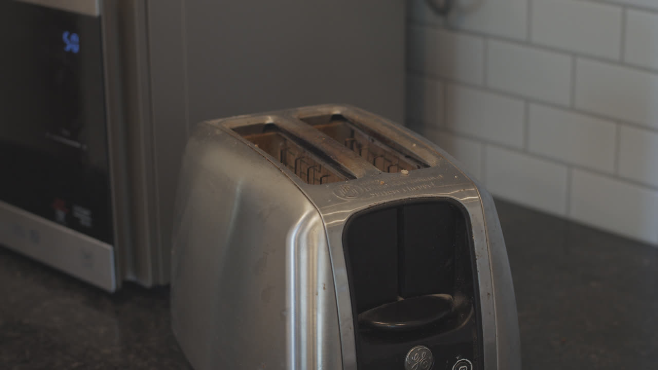 Putting toast in the toaster